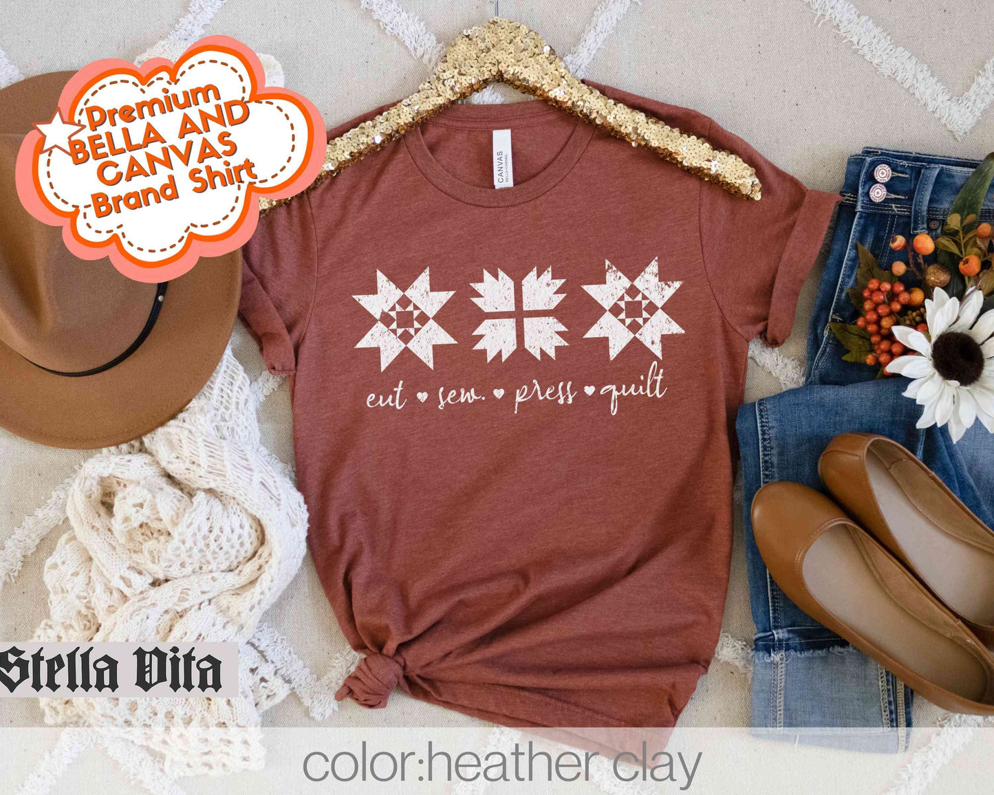 a t - shirt with a cross on it and a cowboy hat next to it