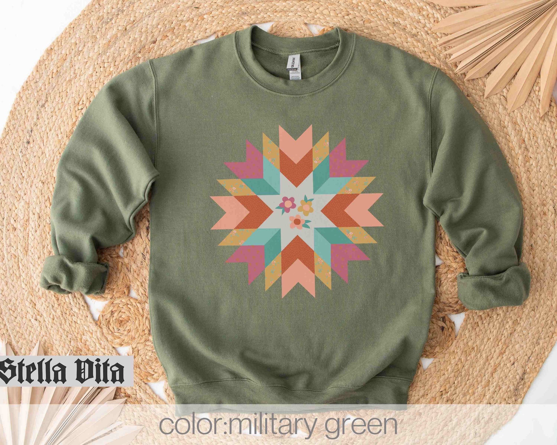 a green sweater with a colorful star design on it