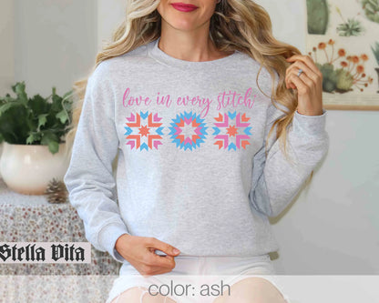 a woman wearing a grey sweatshirt with a colorful design