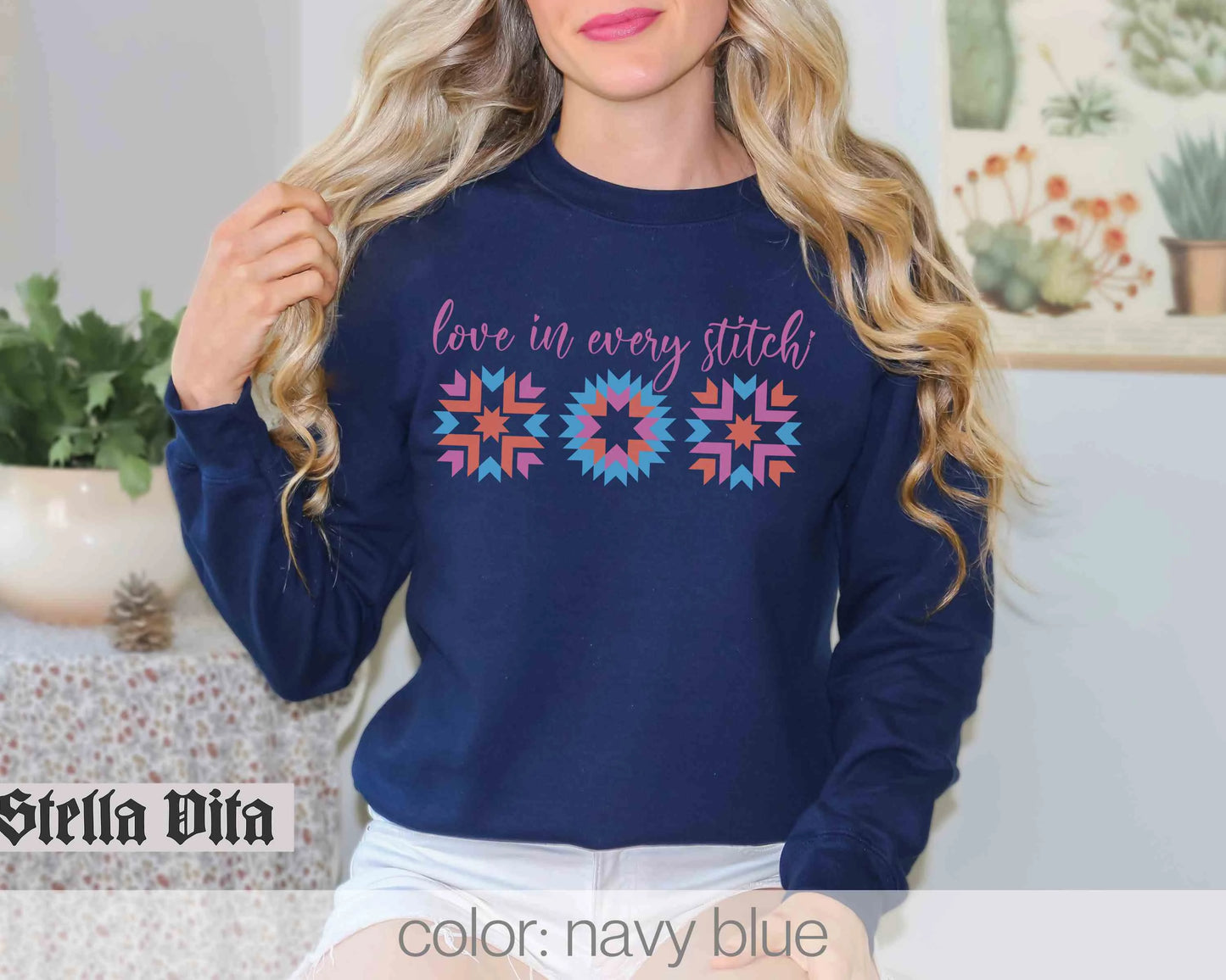a woman wearing a blue sweater that says love in every stitch