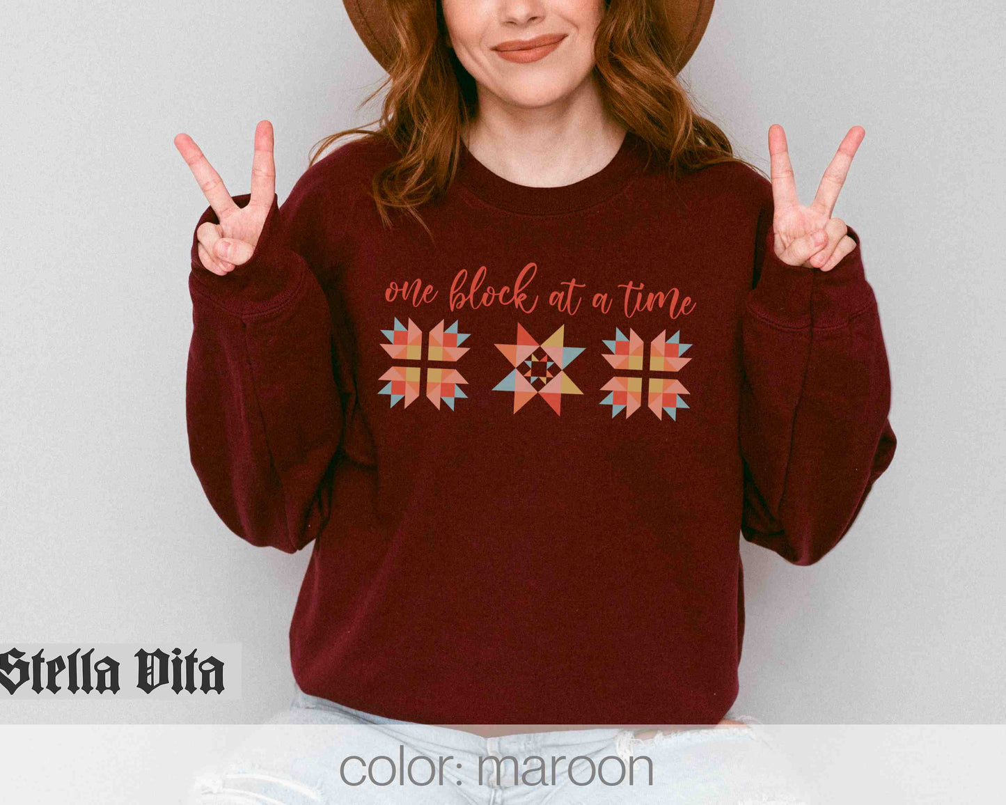 a woman wearing a red sweater and a brown hat