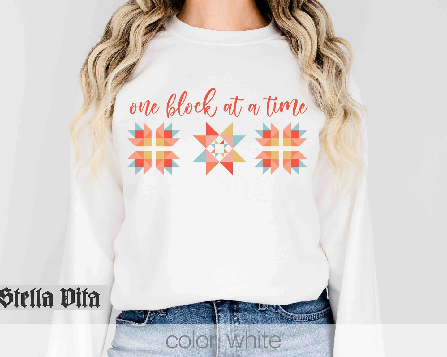 a woman wearing a white shirt that says one block at a time